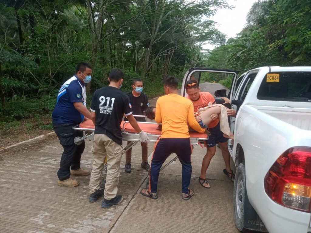 Coast Guard Personnel rescuing a drowned woman and putting her inside a rescue vehicle