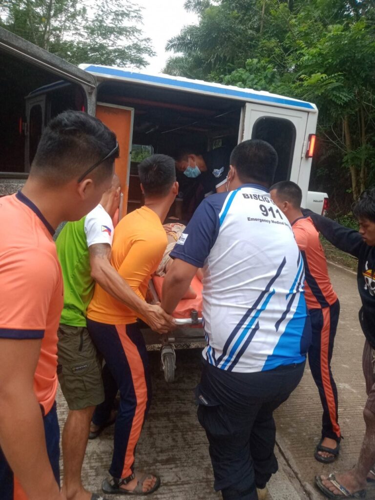 Coast Guard Surigao del Sur Personnel taking the drowned victim to a vehicle for rescue