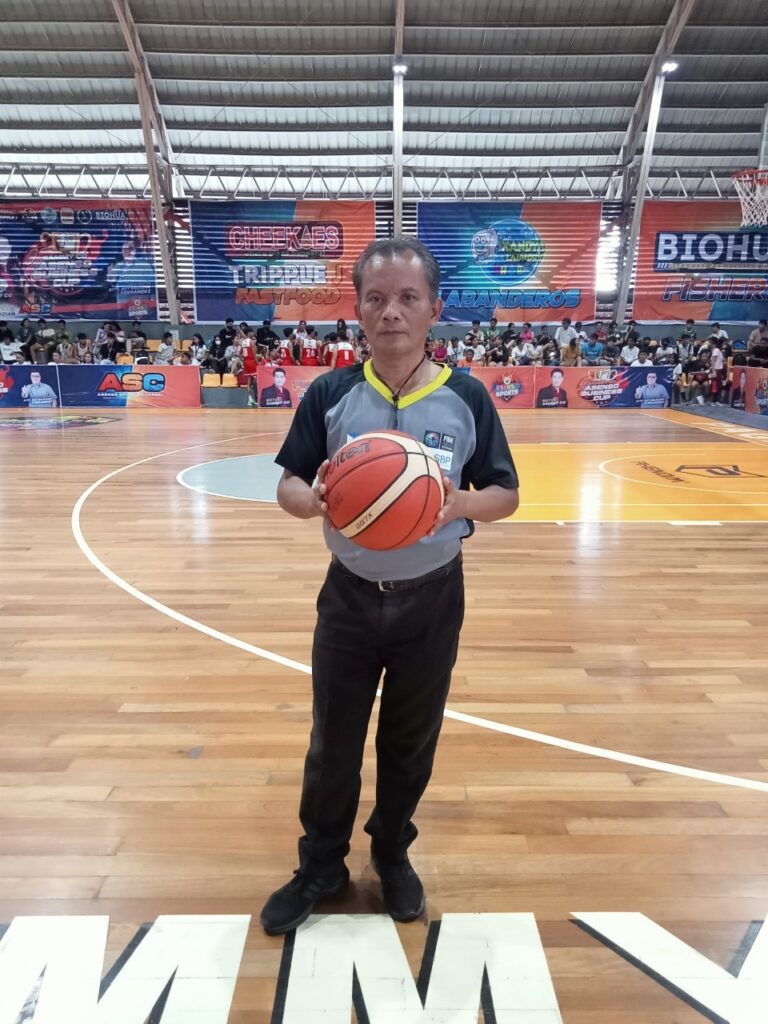 one of the referees holding the ball